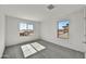 Bright bedroom with neutral carpeting and dual windows at 37536 W Patterson St, Maricopa, AZ 85138