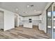 Modern kitchen with white cabinets and an island at 37536 W Patterson St, Maricopa, AZ 85138