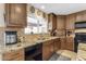 Kitchen with granite countertops, wood cabinets and a double sink at 408 W Straford Dr, Chandler, AZ 85225