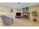 Living area with fireplace, comfortable seating and large screen TV at 408 W Straford Dr, Chandler, AZ 85225