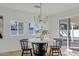 Elegant dining room with a round table, chandelier, and sliding glass door at 4129 E Eugie Ave, Phoenix, AZ 85032