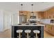 Modern kitchen with island, stainless steel appliances, and light wood cabinets at 4129 E Eugie Ave, Phoenix, AZ 85032