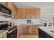 Bright kitchen with wood cabinets, white backsplash and stainless steel appliances at 4129 E Eugie Ave, Phoenix, AZ 85032