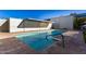 Community pool with tiled deck and shade structure at 4411 N 40Th St # 52, Phoenix, AZ 85018