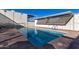 Community pool with surrounding patio and building view at 4411 N 40Th St # 52, Phoenix, AZ 85018