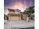 Two-story house with tan exterior, red tile roof, and a two-car garage at 4417 E Rancho Caliente Dr, Cave Creek, AZ 85331