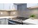 Modern kitchen with gray tile backsplash and stainless steel cooktop at 4417 E Rancho Caliente Dr, Cave Creek, AZ 85331