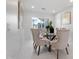 Modern dining room with glass table and six beige chairs at 4437 N Granite Reef Rd, Scottsdale, AZ 85251