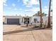 White mid-century modern home with gray garage door and landscaped front yard at 4437 N Granite Reef Rd, Scottsdale, AZ 85251