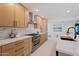 Modern kitchen with light wood cabinets, white countertops and a gas range at 4437 N Granite Reef Rd, Scottsdale, AZ 85251