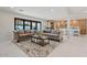 Bright living room features neutral colored couches and flows into the kitchen at 4437 N Granite Reef Rd, Scottsdale, AZ 85251