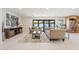 Open living room with beige sofas, a coffee table, and access to the backyard at 4437 N Granite Reef Rd, Scottsdale, AZ 85251