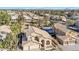 Expansive aerial view of a Southwestern home with a tile roof, palm trees, and community pools at 4968 E Grandview Rd, Scottsdale, AZ 85254