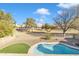 Backyard view with pool, green grass, and mature landscaping at 4968 E Grandview Rd, Scottsdale, AZ 85254