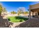 Landscaped backyard with artificial turf and pool at 4968 E Grandview Rd, Scottsdale, AZ 85254