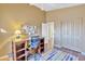 Bedroom featuring a ceiling fan, study desk, and well-maintained hardwood floors at 4968 E Grandview Rd, Scottsdale, AZ 85254