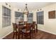 Bright breakfast nook features a wood table and chairs, and large windows at 4968 E Grandview Rd, Scottsdale, AZ 85254