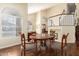 Bright dining room with wood table and chairs, hardwood floors, and view of staircase at 4968 E Grandview Rd, Scottsdale, AZ 85254