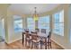 Bright dining area with a wooden table, six chairs and sliding doors to the patio at 4968 E Grandview Rd, Scottsdale, AZ 85254