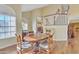 Warm dining room with a wooden table, chairs, and a view of the living room at 4968 E Grandview Rd, Scottsdale, AZ 85254