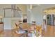 Cozy dining room with a round wooden table, cushioned chairs, and a view of the staircase at 4968 E Grandview Rd, Scottsdale, AZ 85254