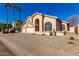 Two-story house with three-car garage, desert landscaping, and palm trees at 4968 E Grandview Rd, Scottsdale, AZ 85254