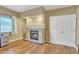 Room featuring a fireplace, hardwood flooring, and a closed doorway at 4968 E Grandview Rd, Scottsdale, AZ 85254