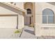 Welcoming front entrance featuring a secured screen door, neutral color palette, and desert plants at 4968 E Grandview Rd, Scottsdale, AZ 85254