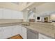 Kitchen featuring granite countertops, stainless steel appliances and white cabinetry at 4968 E Grandview Rd, Scottsdale, AZ 85254