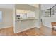 Bright kitchen featuring white cabinetry, breakfast bar, and modern appliances at 4968 E Grandview Rd, Scottsdale, AZ 85254