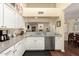 Kitchen with granite countertops, white cabinets, and a view of the living room at 4968 E Grandview Rd, Scottsdale, AZ 85254