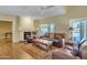 Comfortable living room with a fireplace, ceiling fan, and sliding glass door to a backyard at 4968 E Grandview Rd, Scottsdale, AZ 85254