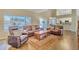 Spacious living room featuring hardwood floors, a ceiling fan, and a sliding glass door to a backyard at 4968 E Grandview Rd, Scottsdale, AZ 85254