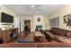 Living room with leather couches, hardwood floors, and a view to the kitchen at 4968 E Grandview Rd, Scottsdale, AZ 85254