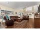 Open living room with leather furniture, hardwood floors, and a view of the kitchen at 4968 E Grandview Rd, Scottsdale, AZ 85254