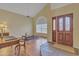 Bright living room with a high ceiling, wood floors, front door, and large window at 4968 E Grandview Rd, Scottsdale, AZ 85254