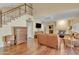 Open-concept living room with a staircase, wood flooring, and plenty of natural light at 4968 E Grandview Rd, Scottsdale, AZ 85254