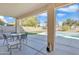 Covered patio with outdoor seating and view of the pool and landscaped backyard at 4968 E Grandview Rd, Scottsdale, AZ 85254