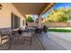 Covered patio with seating area and backyard access at 4968 E Grandview Rd, Scottsdale, AZ 85254