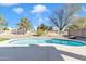 Beautiful backyard pool surrounded by well-maintained landscaping and a fence at 4968 E Grandview Rd, Scottsdale, AZ 85254