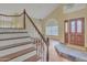 Staircase leading upstairs with wood treads, white risers, and a decorative wood banister at 4968 E Grandview Rd, Scottsdale, AZ 85254