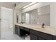 Double vanity bathroom with dark cabinets and large mirror at 5109 E Blanche Dr, Scottsdale, AZ 85254