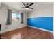 Bedroom with blue accent wall and wood flooring at 5109 E Blanche Dr, Scottsdale, AZ 85254