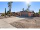 Ranch-style home with a two-car garage and mature palm trees at 5109 E Blanche Dr, Scottsdale, AZ 85254