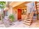 Condo entry with red door, stairs, and landscaping at 5122 E Shea Blvd # 1029, Scottsdale, AZ 85254