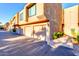 Exterior view of a two-story building with attached garages and landscaping at 5122 E Shea Blvd # 1030, Scottsdale, AZ 85254