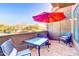 Private patio with seating, red umbrella, and storage at 5122 E Shea Blvd # 1030, Scottsdale, AZ 85254