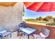 Spacious patio with red umbrella and seating for guests at 5122 E Shea Blvd # 1030, Scottsdale, AZ 85254