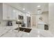 Modern kitchen with white cabinets, marble counters, and breakfast bar at 5505 E Mclellan Rd # 99, Mesa, AZ 85205