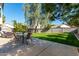 Backyard patio with dining table and lush green grass at 553 S Meadows Dr, Chandler, AZ 85224